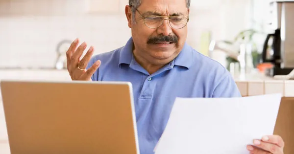 Frustrated man looking at documents
