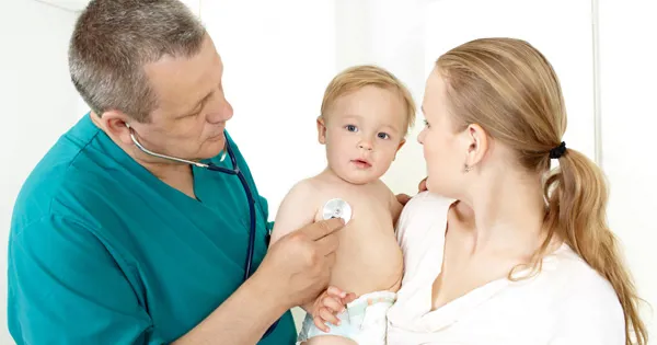 doctor checking baby with mother