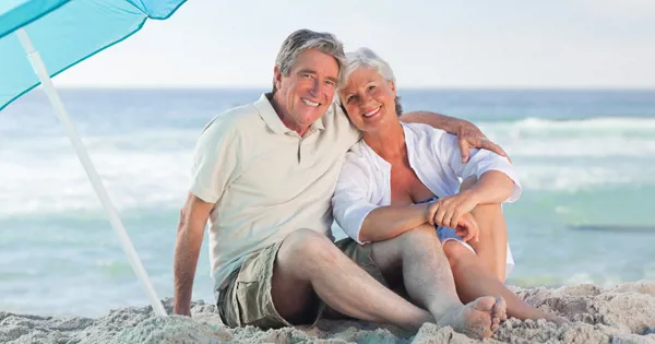 seniors in good health relaxing on beach