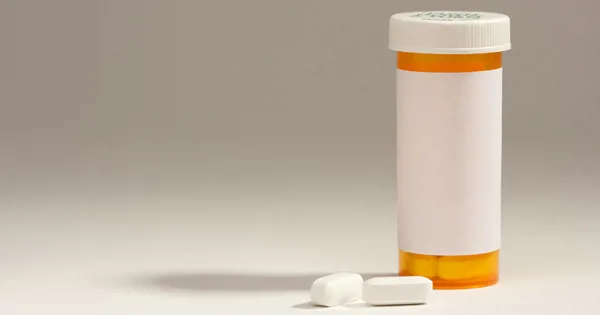 blank prescription bottle and pills