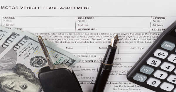 car lease contract with calculator keys and money