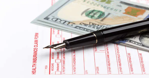 Health insurance form pen and money