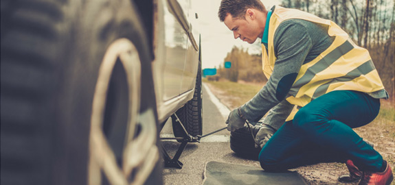 Roadside assistance fixing flat tire