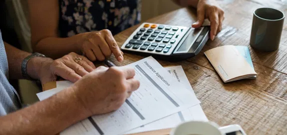 couple filling out health insurance application form