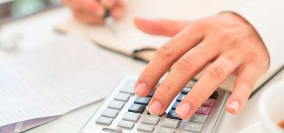 man using calculator and pen