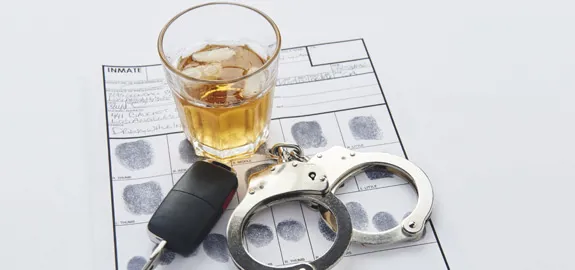 glass of whiskey car keys handcuffs and fingerprints