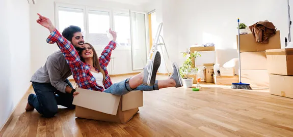 young couple in home with moving boxes