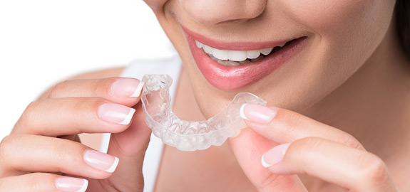 woman holding mouth guard oral appliance