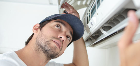 Man fixing air conditioning