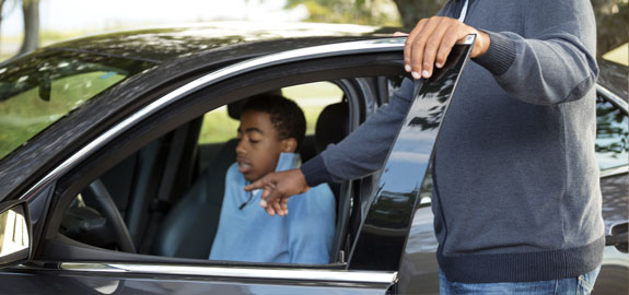 Father helping teen driver